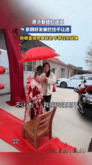 男子娶媳妇进门，新娘下车朝婆家走去，不料，却被男方的一群亲友拦住不让进门，新娘直