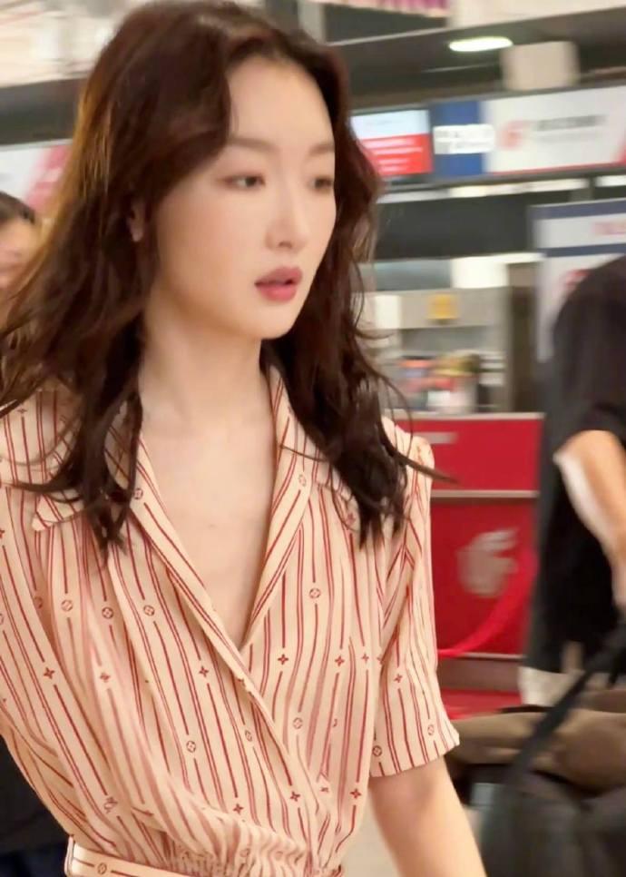 网友在北京机场偶遇了周冬雨，她身穿橙色条纹衬衫裙，妆容精致，许久未见状态不减！