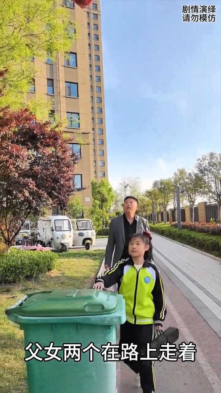 女儿花式扔垃圾袋让爸爸看的一脸懵。
父女两个在路上走着，这时女儿把受伤的垃圾袋往
