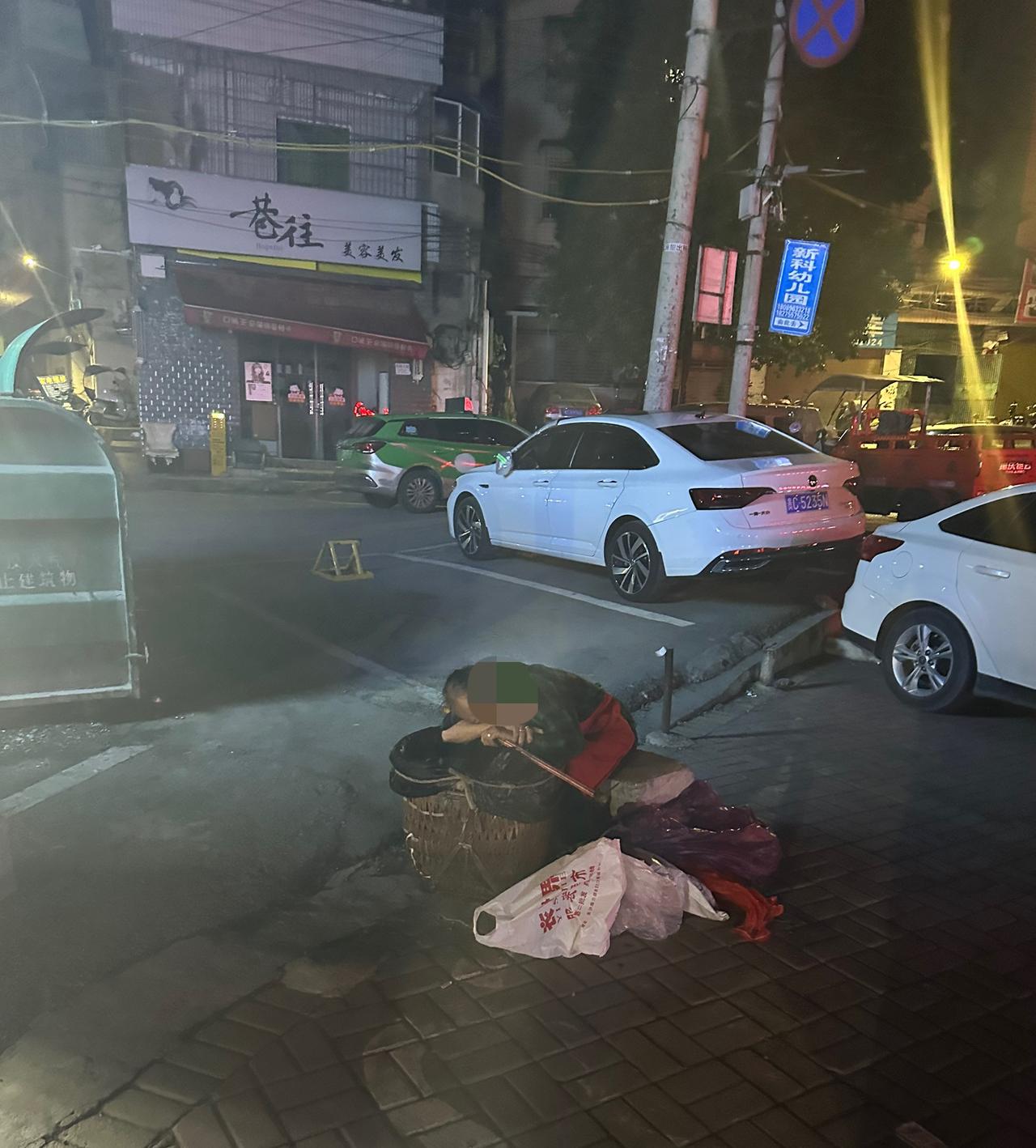 太不容易啦！这么晚了老人为了捡一点废品竟然在垃圾箱旁睡着了！
      本来应