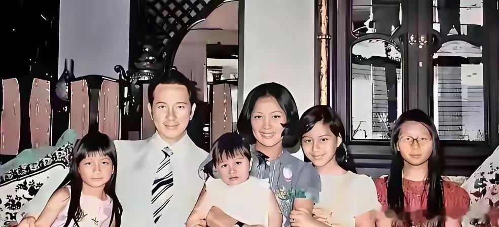 何超蕸小的时候和家人在一起的合照，被爸爸搂着，安安静静的，模样娇俏可爱，特别讨喜