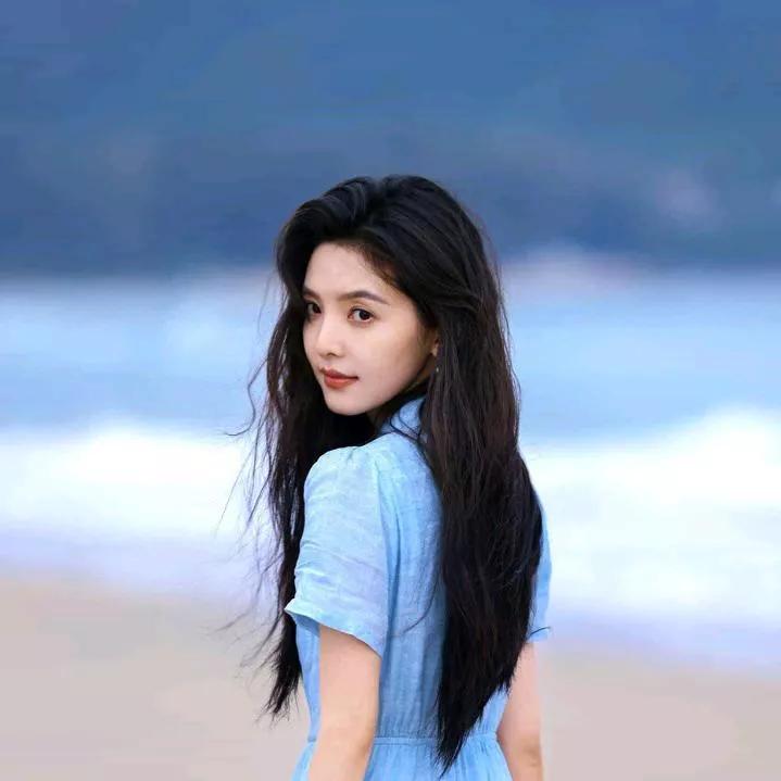 温柔的海风轻拂过，蓝色连衣裙少女背影迷人。