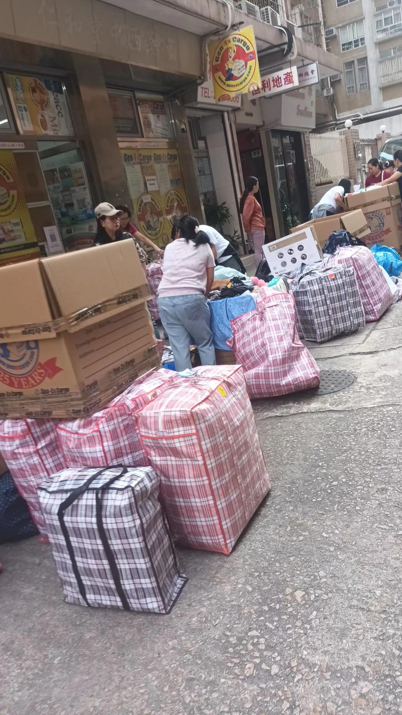 每逢星期日早上，里街住家楼下路旁大包小袋待装箱邮菲杂物。据统计目前有逾20万菲籍
