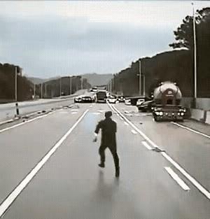 这事儿真是让人捏了把汗！视频里头，有个哥们儿在马路上撒腿狂奔，后头有一辆车紧追不