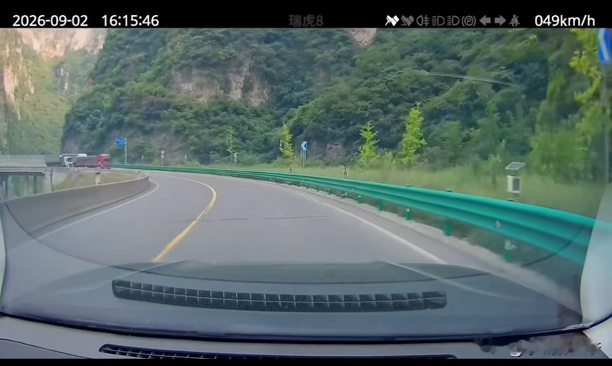 入弯道前，瑞虎8已发现红色大车已经打了左闪进行提示后车，白色大车依然选择在弯道超