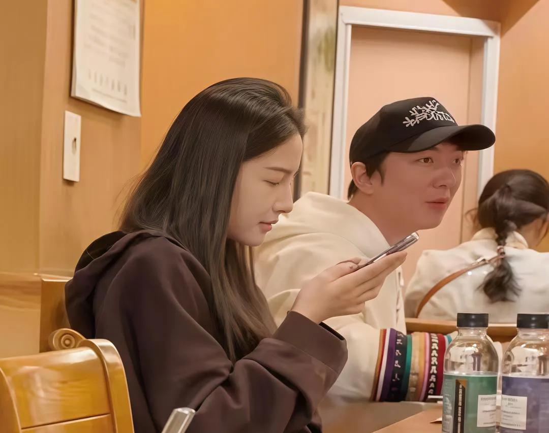 王思聪和女友现身韩国饭店吃饭，女友坐在他身边抬手玩手机，王思聪左顾右盼不知道在看