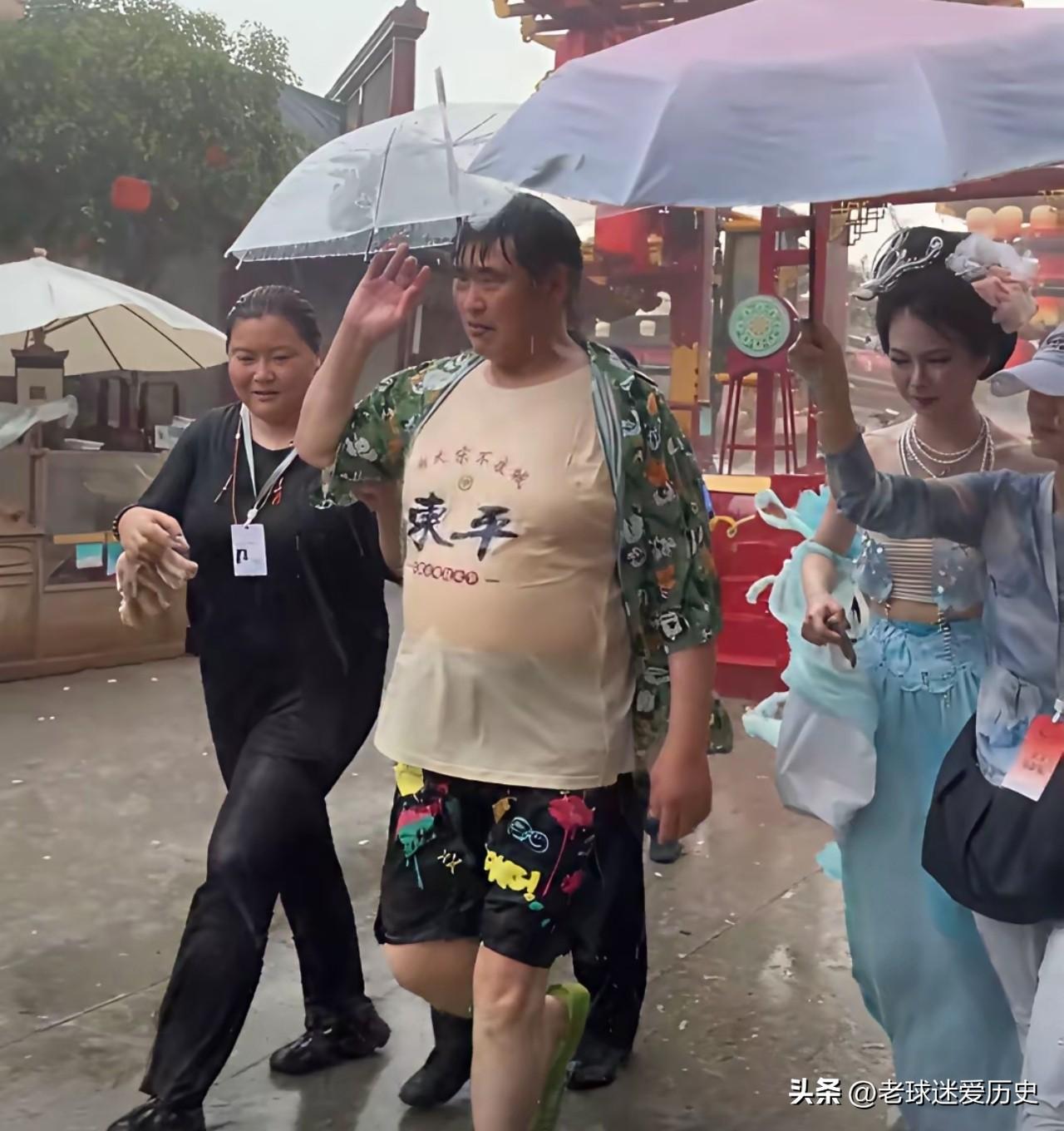 下这么大的雨还坚持演出，还不打伞，这钱活该他挣。