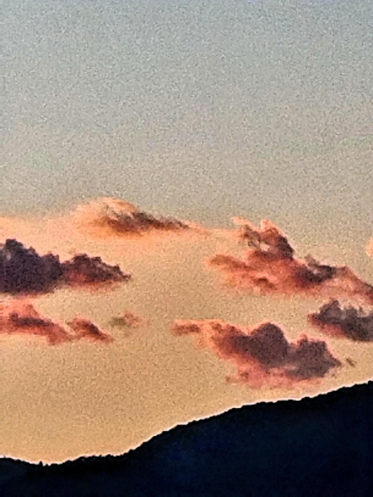 云朵的形状瞬息万变，时而像一头咆哮的雄狮，鬃毛在余晖中飞扬；时而又似一条蜿蜒的巨