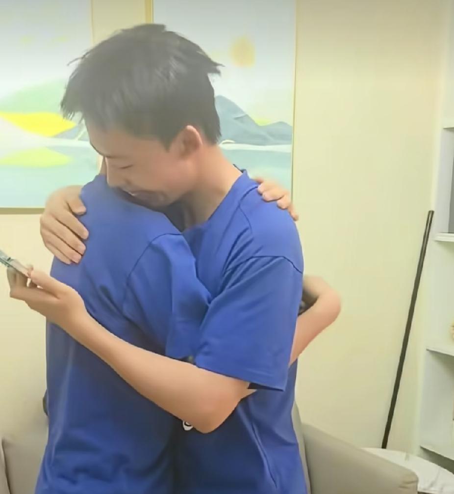 双胞胎兄弟都在盯着手机查高考分数，突然就拥抱在一起，听到分数时，更是让人直呼太神