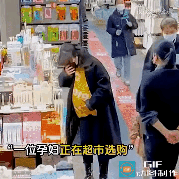 泪目了！一名孕妇正在超市里慢慢选购东西，一男子在经过孕妇身边的时候一直盯着她的后