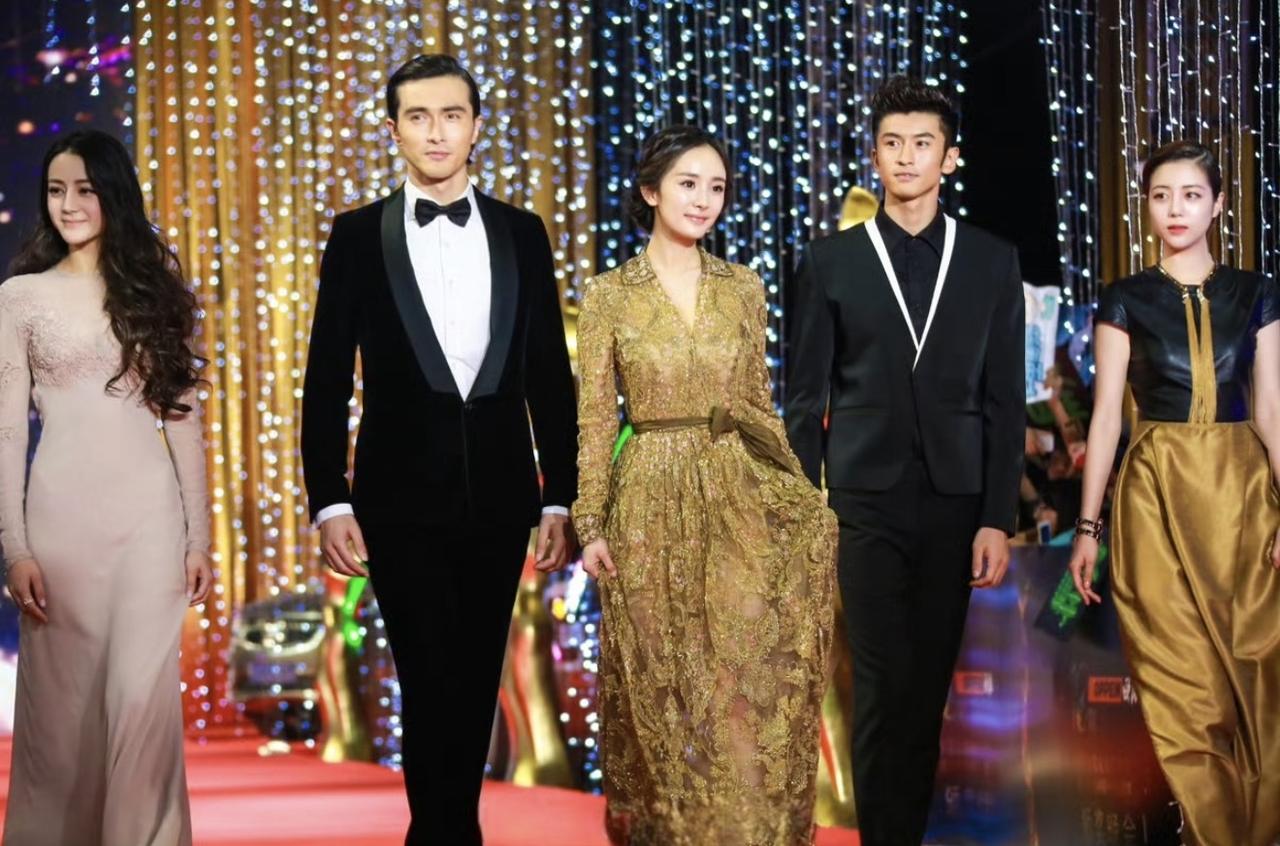 2014年，杨幂带着旗下艺人迪丽热巴、高伟光、张云龙、李溪芮走红毯时的画面。
