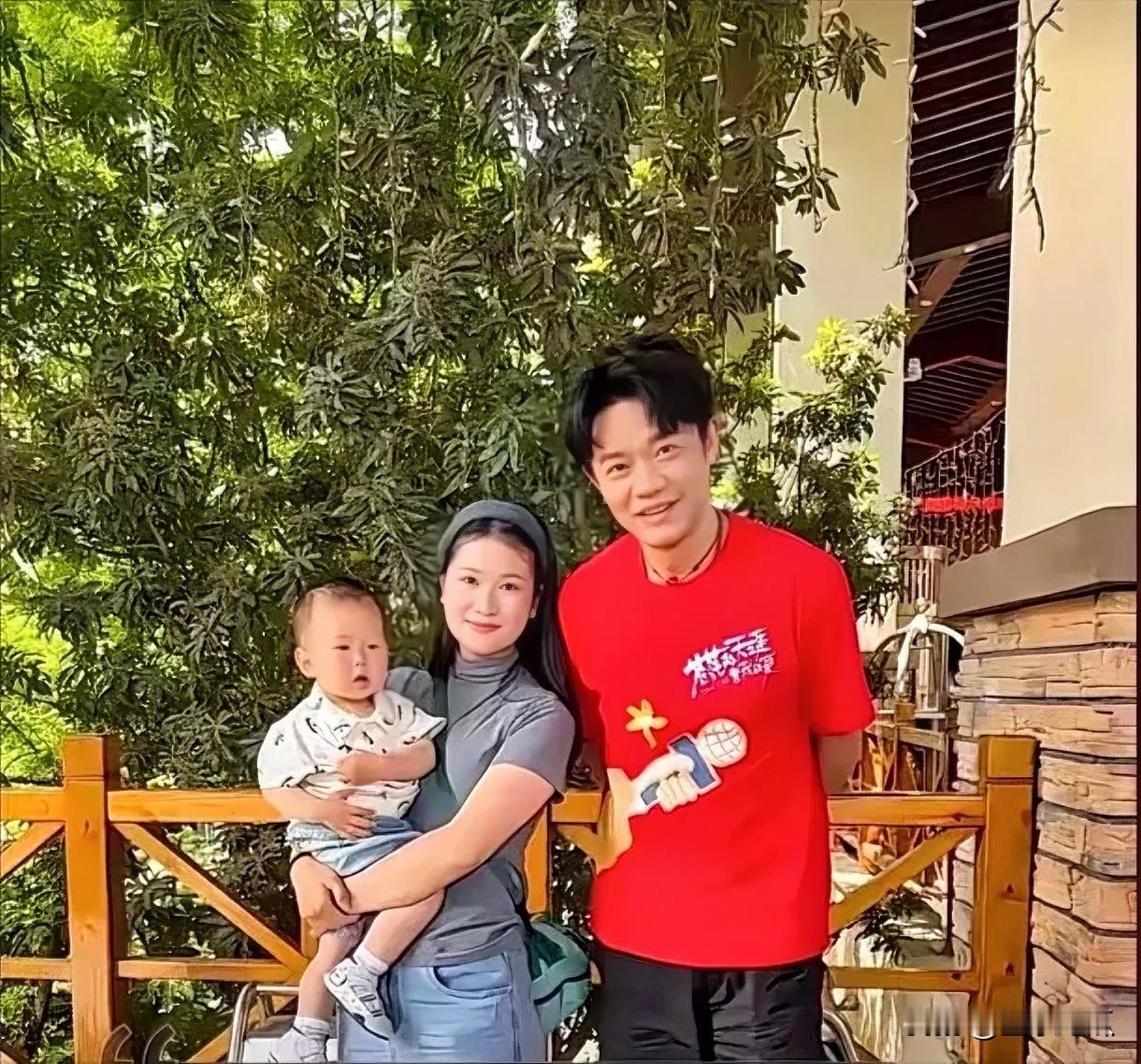 会唱歌的曾毅在老婆面前就似一个普通的居家男人，身着简约的红色T恤，脚蹬一双大头鞋
