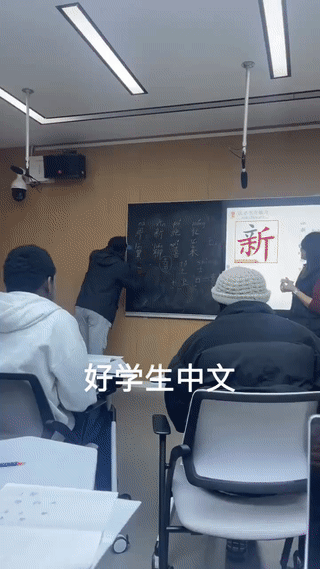 黑人留学生在大学课堂上学写中文汉字。
虽然他写的很生疏，但是一笔一划却写的非常认