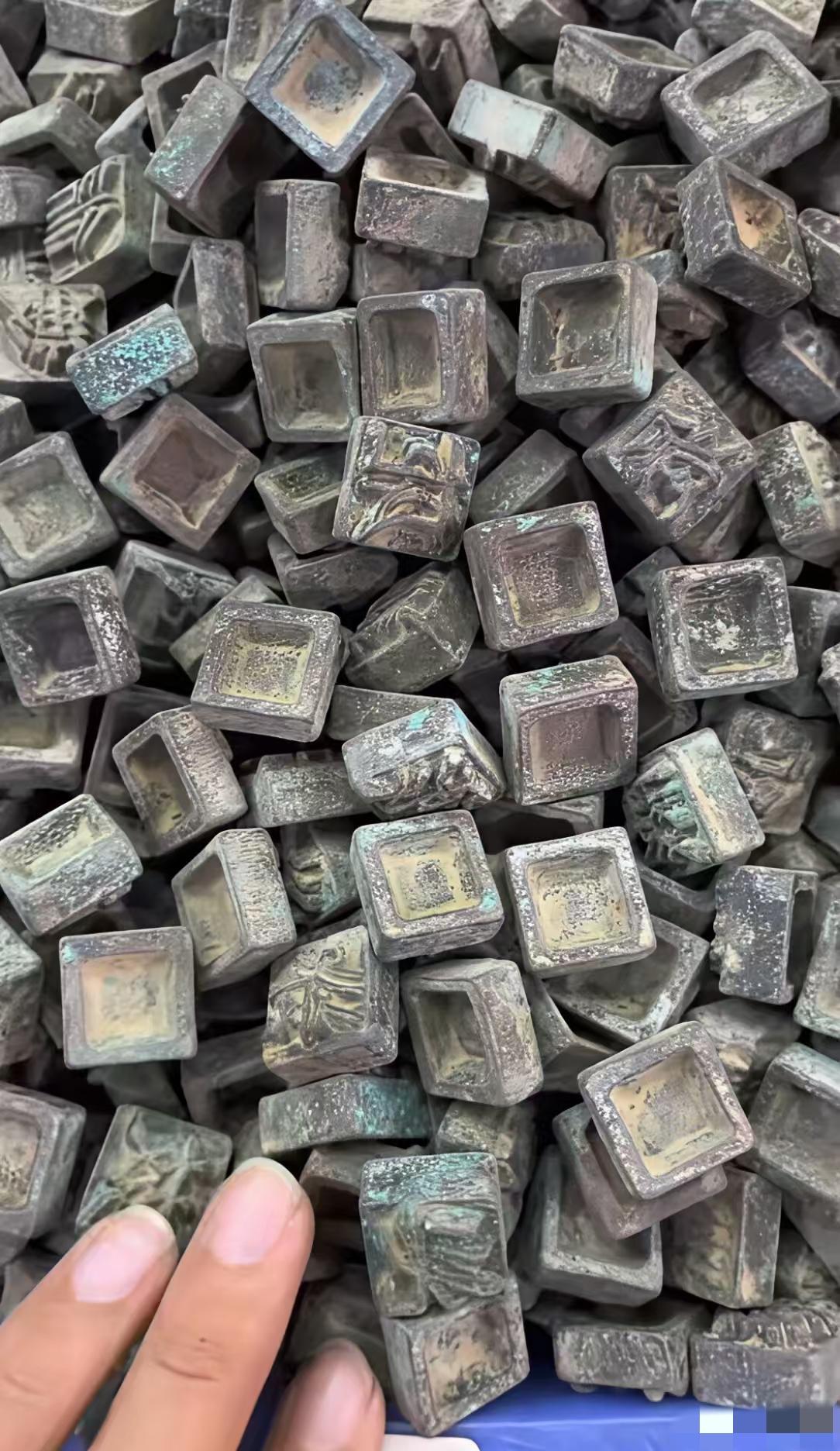 在一位老人家里发现了很多四四方方的小铜块
铜块背面都刻有字，字体不认识，据老人讲