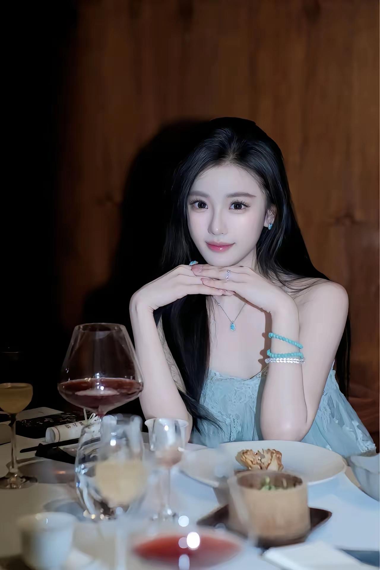 这衣服颜色让人看着真舒服
 
暖调的暗木背景里，一桌餐食与酒杯晕开柔和的光斑，身