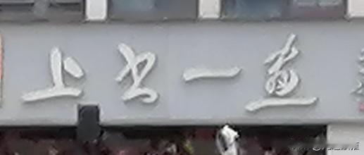 这家店的招牌看起来挺显眼的。
这是一家店的招牌，上面写着四个字。
第一个字和第三