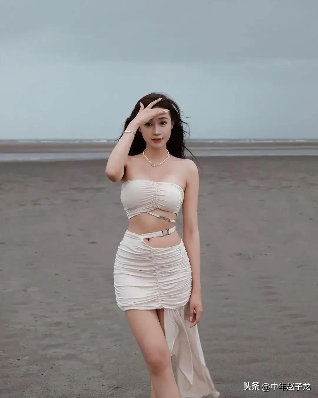 美女
 
灰调的阴天海滩没有刺眼的烈日，漫无边际的滩涂连着远处朦胧的海平线，风卷
