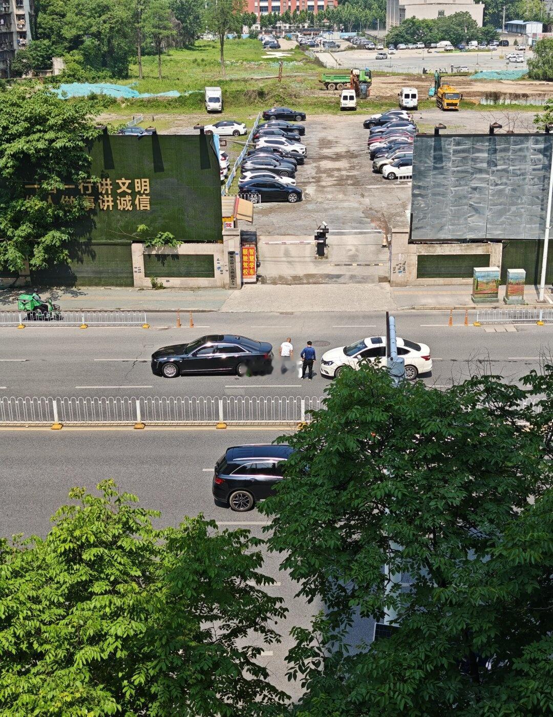 都不晓得开双闪，把车移到道路边上再处理。
白色的日产 追尾黑色凯迪拉克 ，他们两