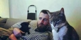 男子手上抱着一只小黑狗，家里的猫看到后[并不简单]猫：哼！你抱小猫也就算了，现在