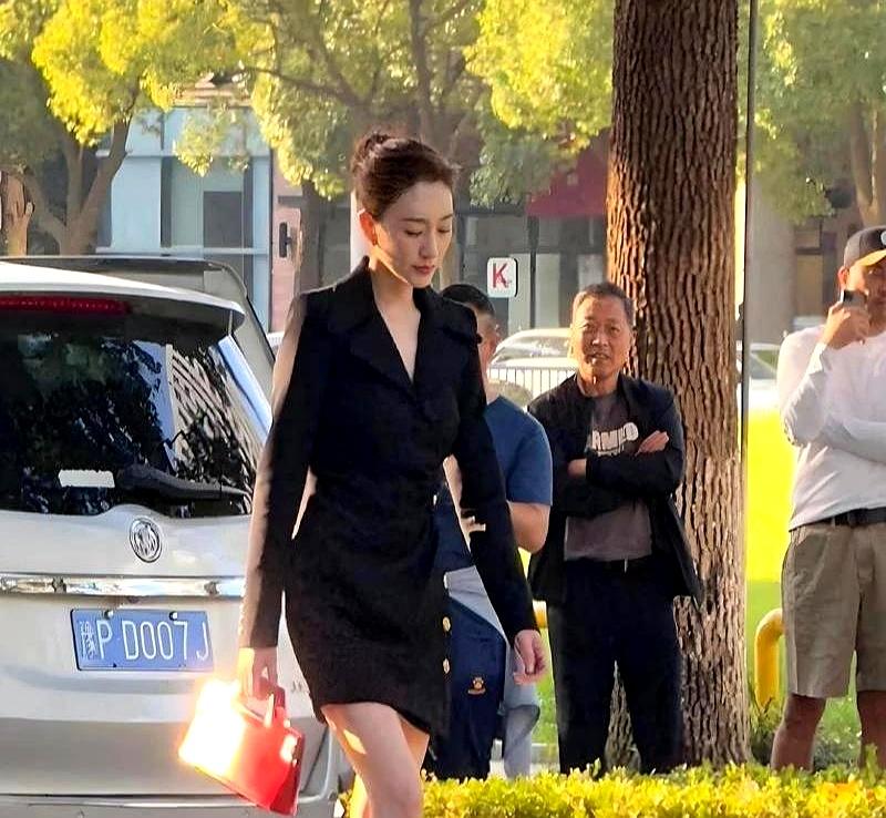 在街角被认出来时，李小冉一停步，人群像被按了暂停。
身段是真高，线条也干净，眉骨