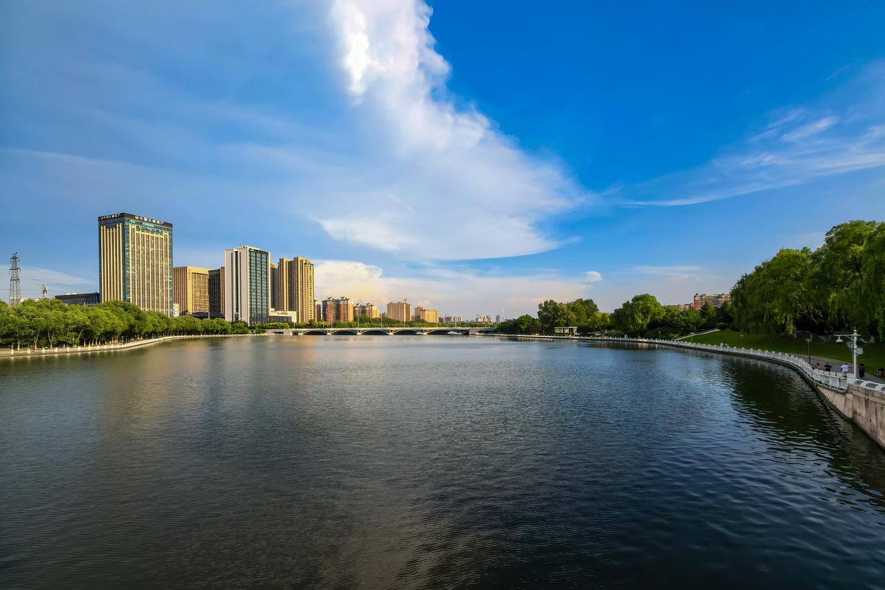 河畔青绿
 
盛夏伊通河，一水清宁，两岸含翠。流云浮于天际，清波漾于水岸，拱桥静