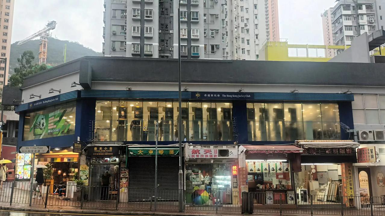 今天的雨下个没停，大街小巷湿漉漉，那边敞开大门的赛马会投注站灯火通明，直播赛马和