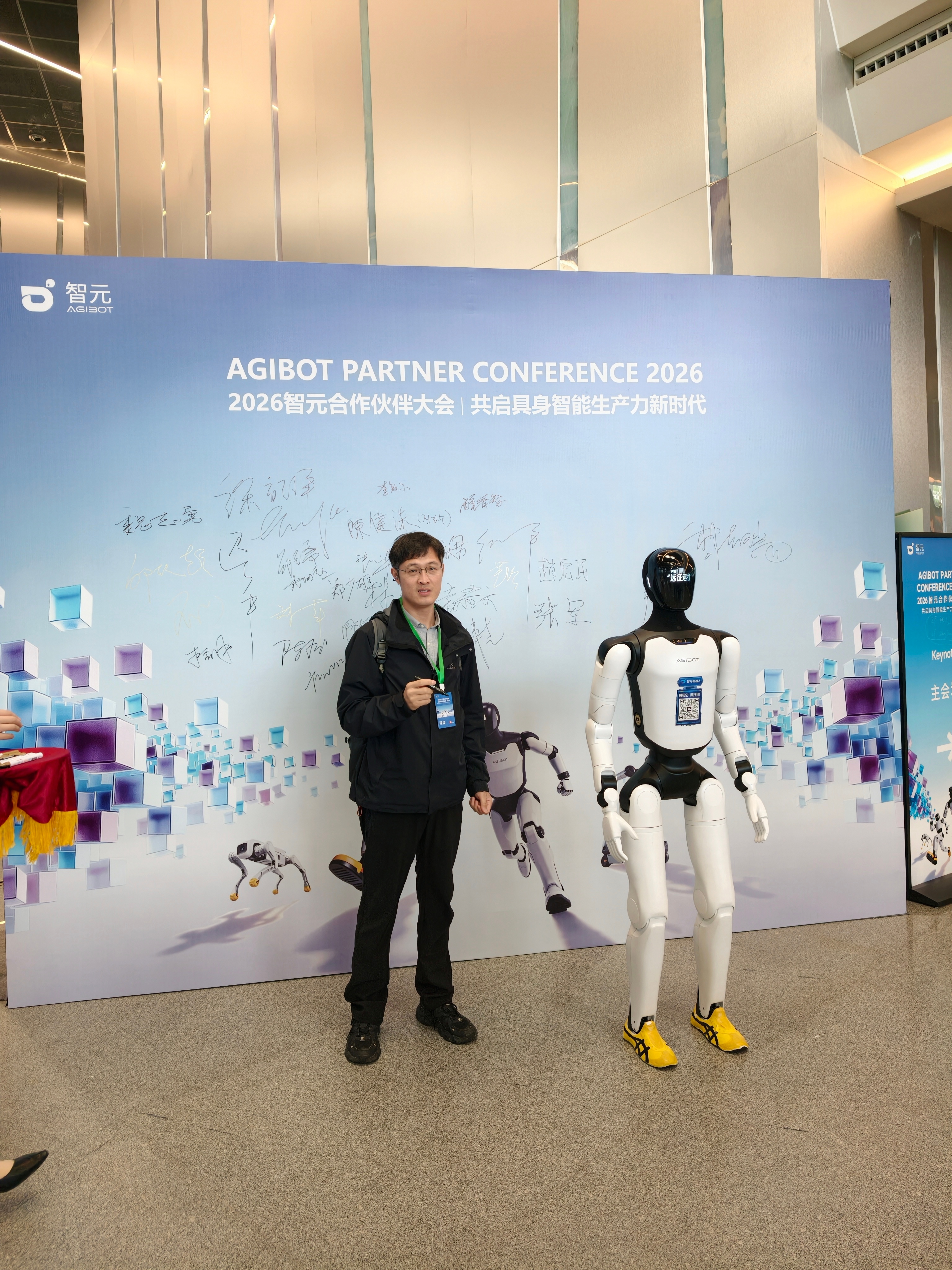 打卡2026智元合作伙伴大会现场，签到合影，这台远征机器人，身高、体重和我很接近
