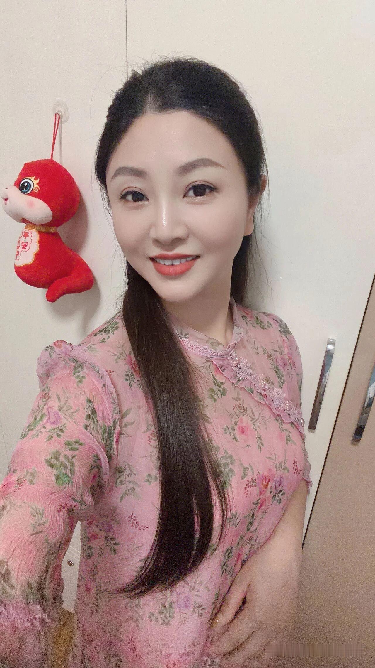 穿粉色花裙的微笑女孩。