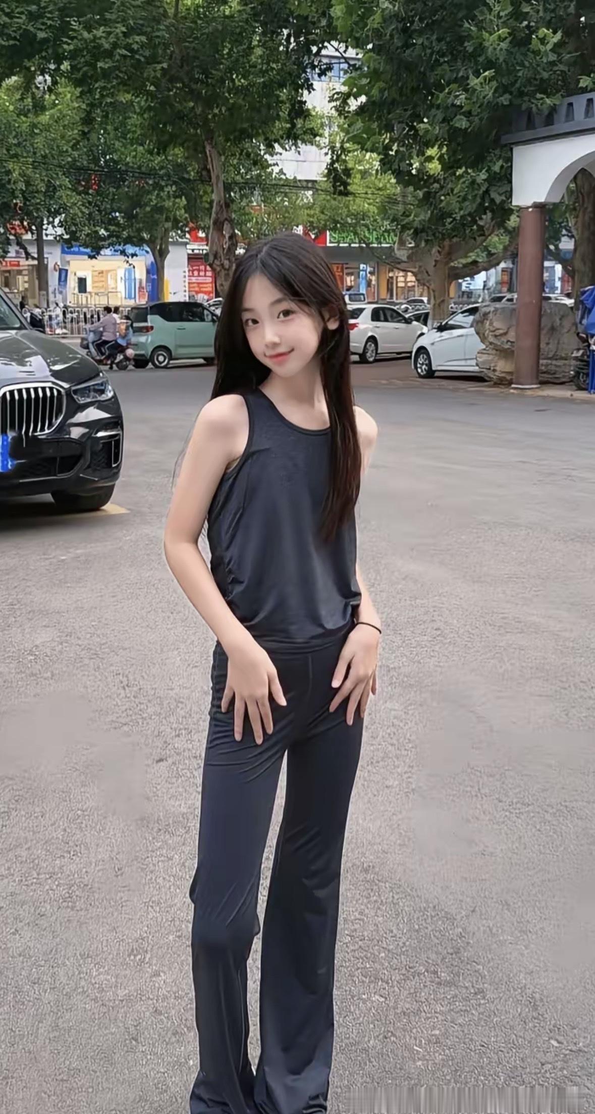 都市时尚少女，黑色无袖上衣搭配宽松牛仔裤，自信满满！