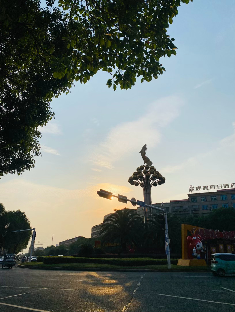 高考倒计时朝沐晨光赴考场，笔携锋芒启新章晨光铺洒路面，落日揉碎霞光，眼前小城晨昏