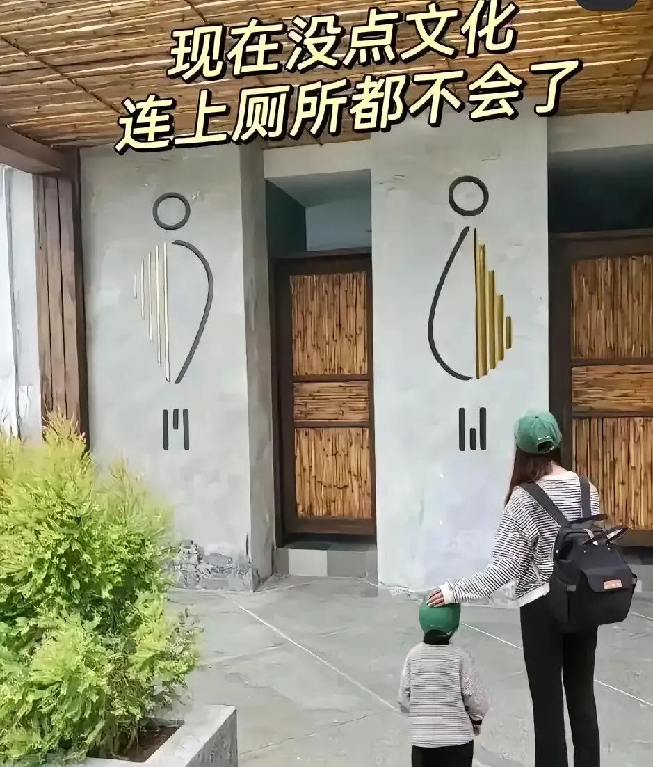 这下完犊子了！竟然分不清男女了…
一位年轻的母亲和小孩站在厕所门口，门上图形清晰