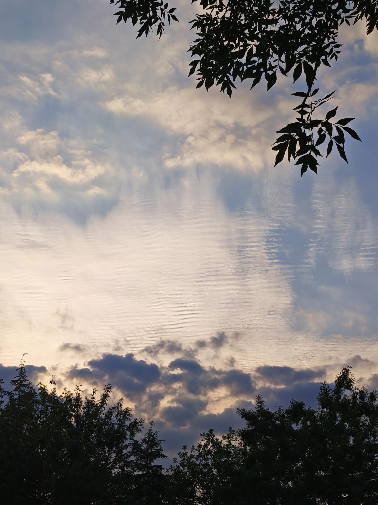 傍晚出去跑步健身，夕阳西下，拍到了一组奇特的层云图片，恰似碧波荡漾的湖水，如果再