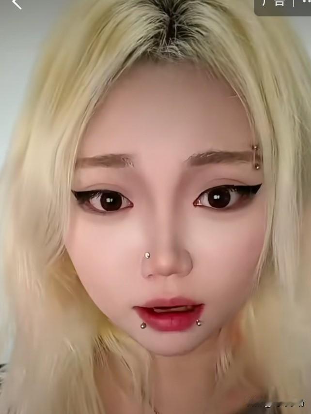 这位金发女孩的嘴上、鼻子上和眉毛上都挂着小珠子，真不知她洗脸时是否要取下来。
好