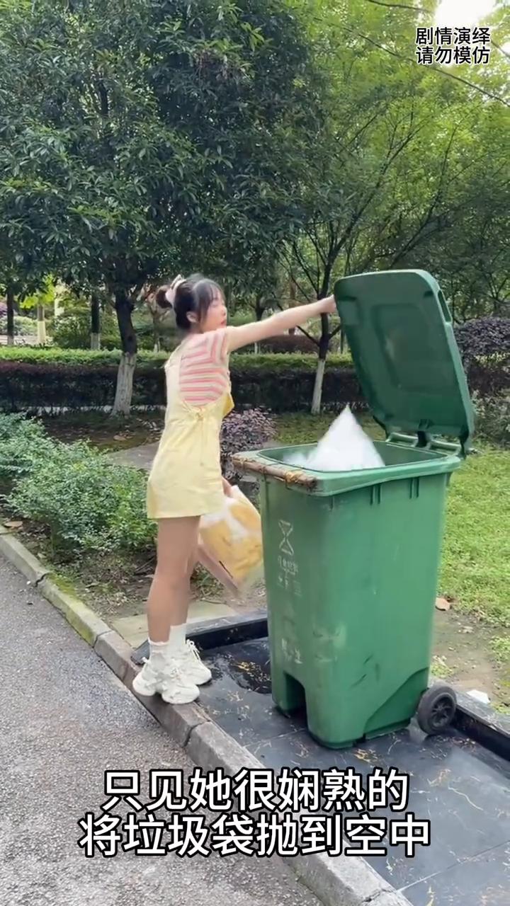 女子巧妙将垃圾袋扔到桶里。
女子来到楼下去扔垃圾袋，只见她很娴熟的将垃圾袋抛到空