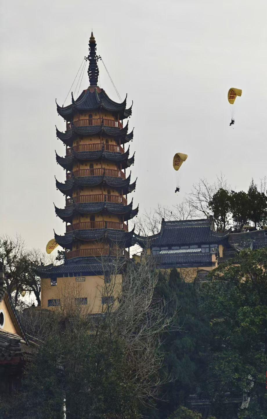 天南地北大拜年古刹飞伞，动静之间，是千年的沉稳与此刻的自由。风掠过飞檐，伞翼载着