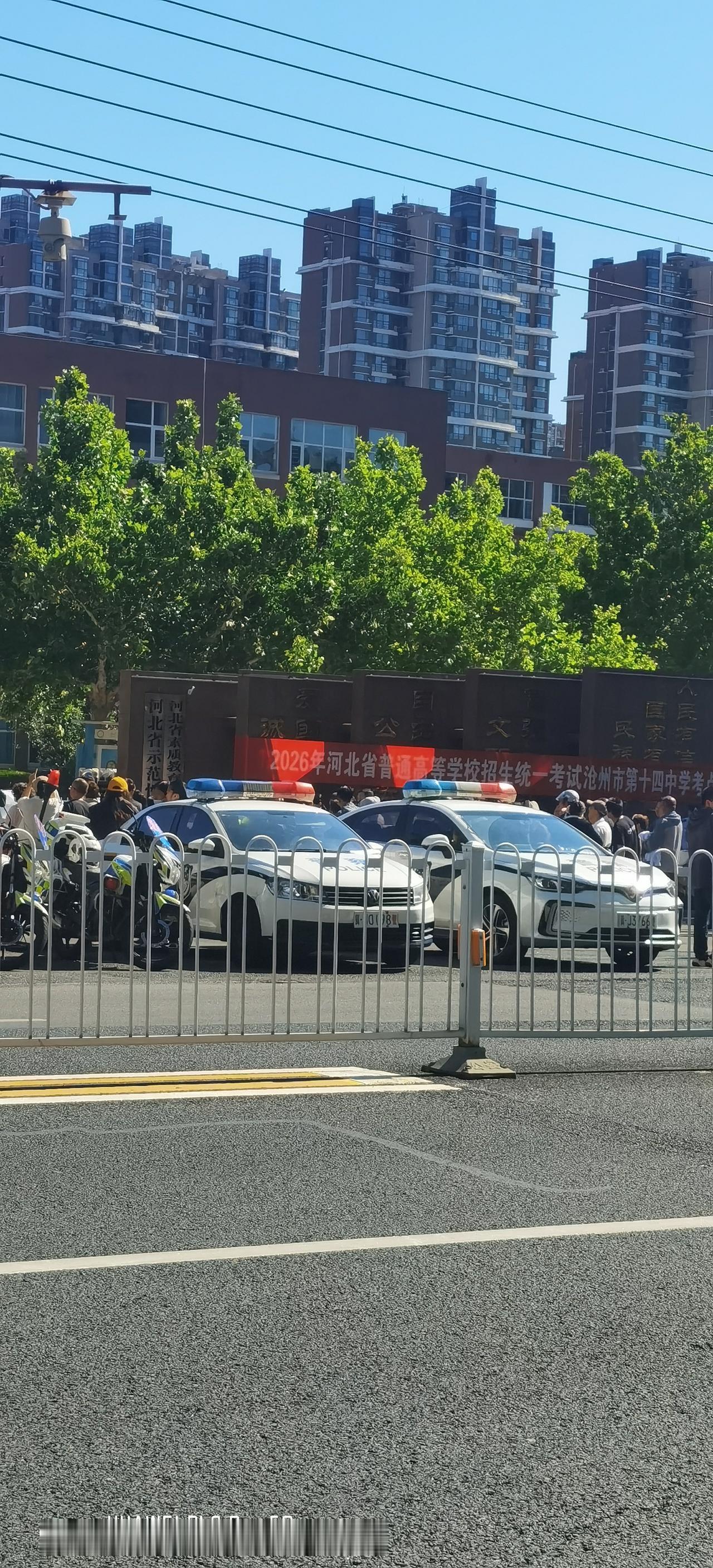 今天是高考的第一天，这是十四中考点，考生早已进入考场，校门口两侧是等候的家长。