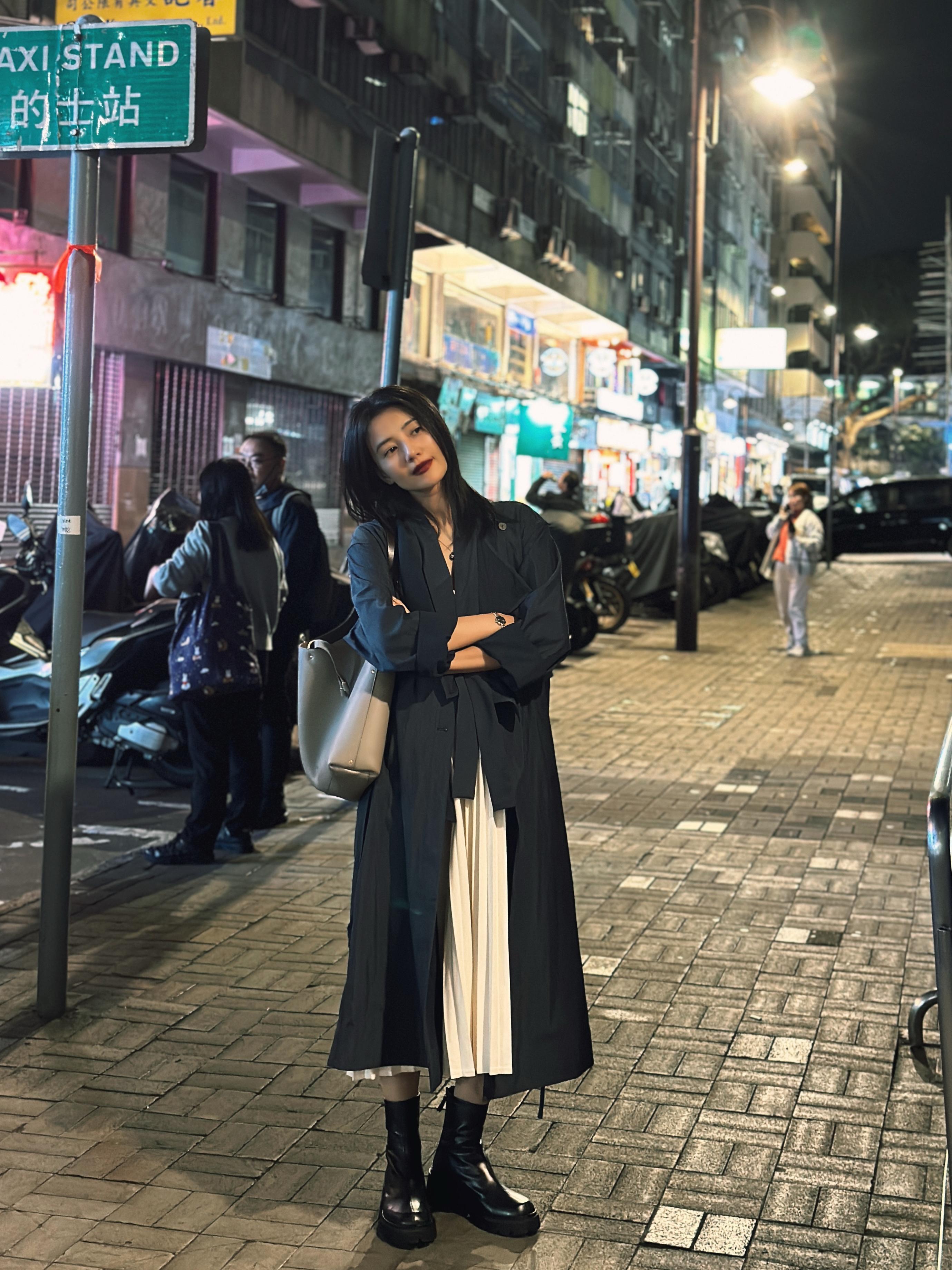 街拍氛围感直接拉满！夜幕下的街道霓虹闪烁，复古又鲜活。她一身松弛随性的穿搭，黑风