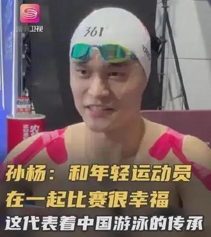 孙杨站在泳池边，肩膀上贴满了胶布，目光紧紧盯着成绩显示屏，久久伫立 。此次他与费