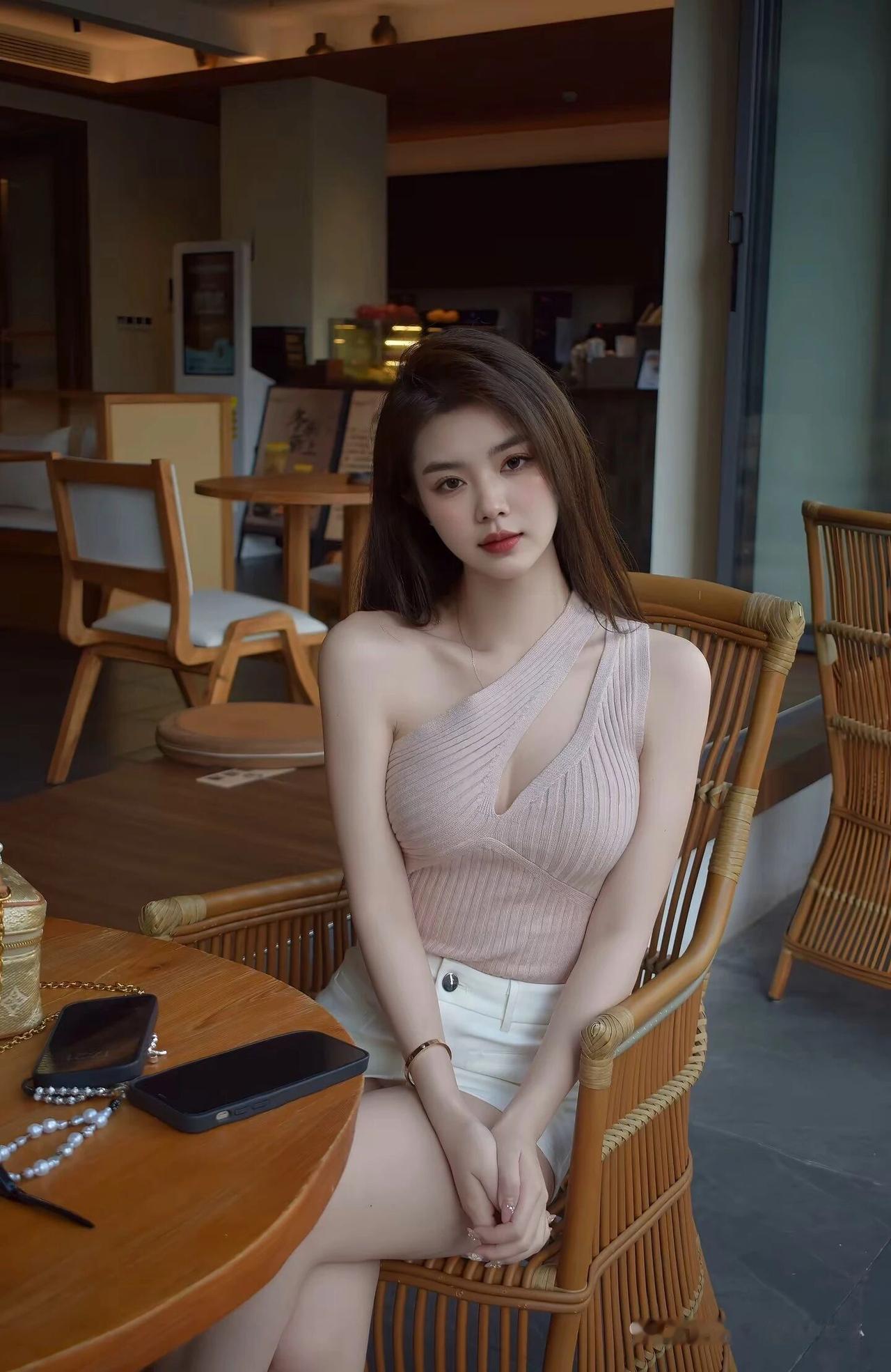 在那优雅咖啡馆里，少女静坐，浅笑嫣然，宛如一幅绝美的画卷。
未动心之人置身其中，