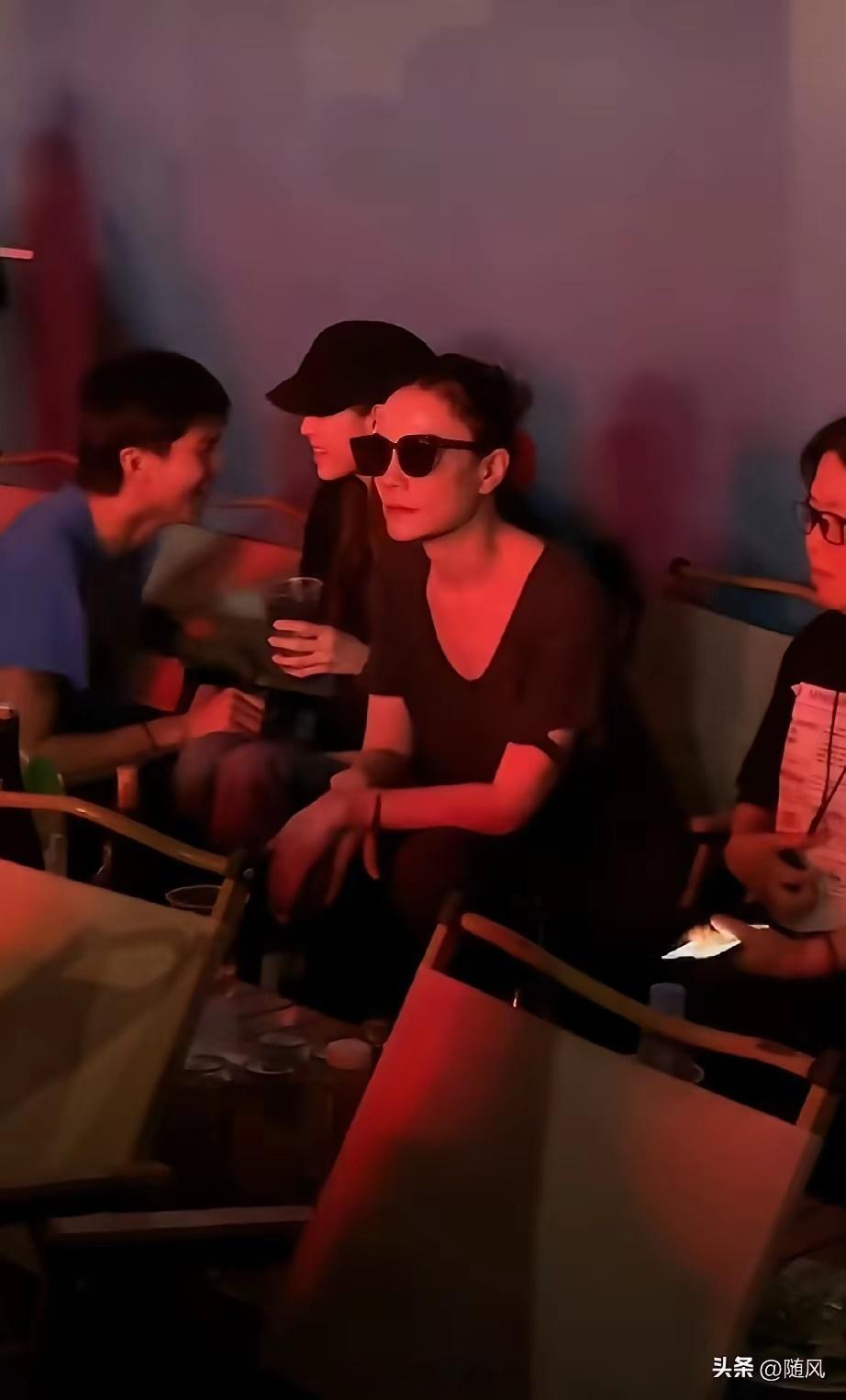 欧阳娜娜把手搭在瑞恩的肩上，瑞恩搂着欧阳娜娜的腰部，王菲在边上静静的听唱歌，后来