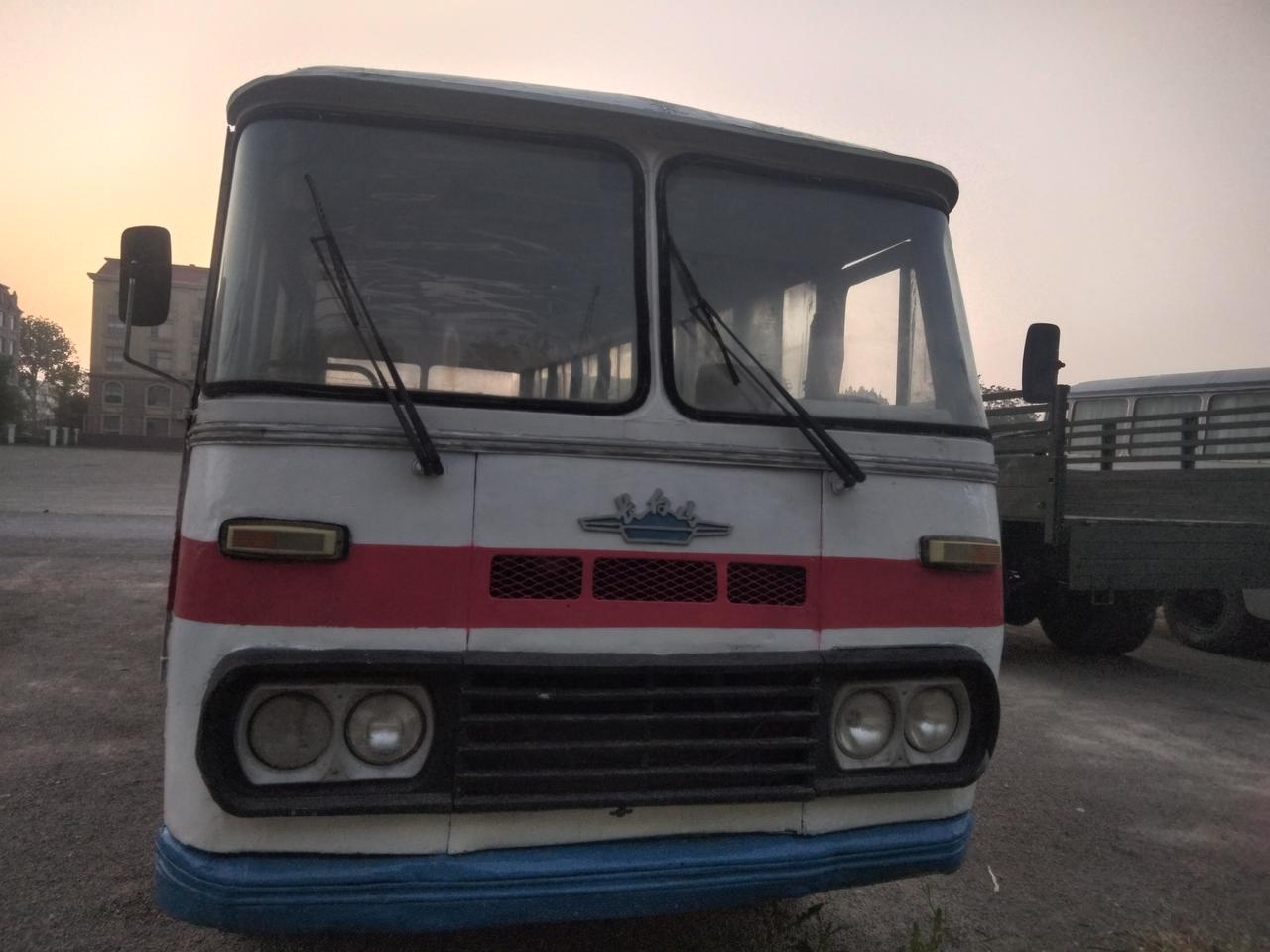 《客车》
旧轮停在风里！紅蓝色的条纹，牵着当年土路的尘；它晃着一代人的归期，慢悠