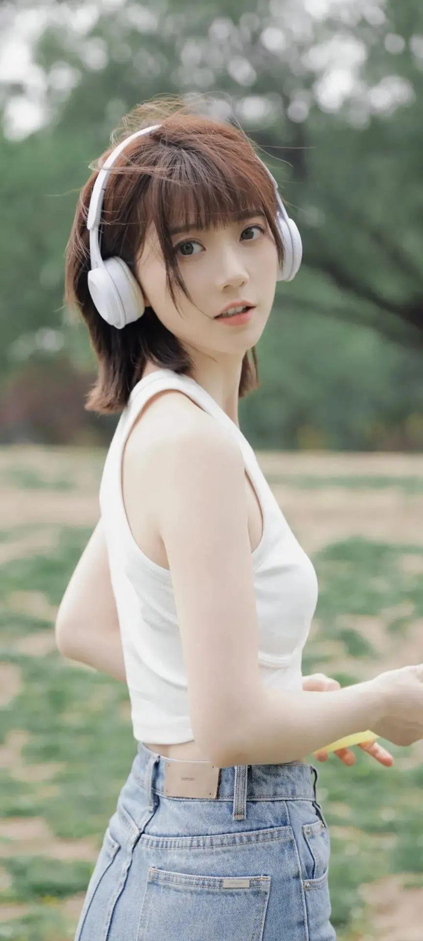换新壁纸啦！浅绿的公园做背景，低饱和的色调很舒服。白色耳机与背心呼应，清清爽爽；