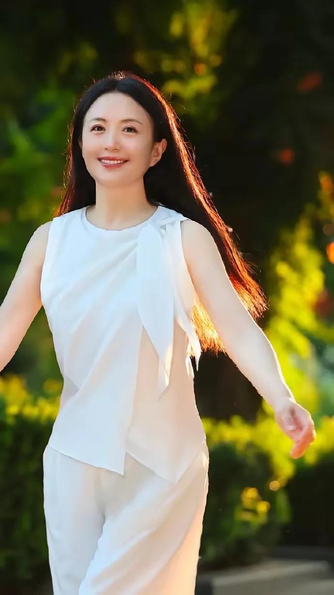 杨童舒一身白衣漫步光影里，温婉氛围感拉满。
素净简约的白色套装，不张扬、不花哨，