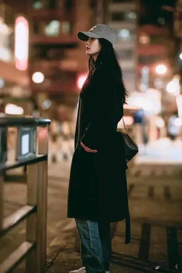 都市夜色中的独行者，黑色大衣与街灯交相辉映。12月星光璀璨夜，刘诗诗工作室揭秘她