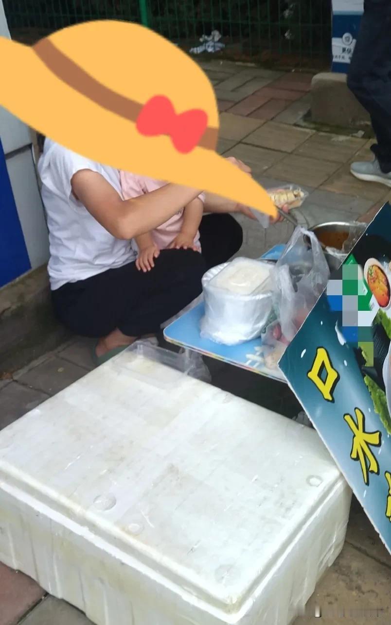 本来都走过去了，可是又被小孩子的哭声拉回来了。这个妈妈一边给顾客准备饭食，一边哄