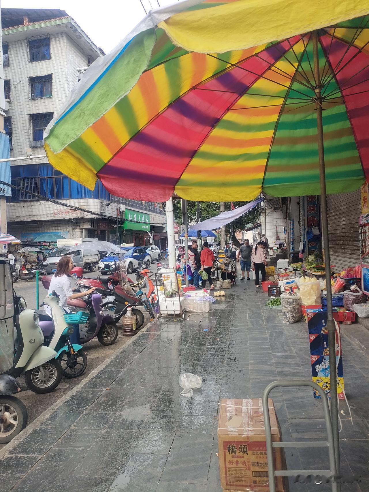 今早赶上班的时间下了一场秋雨，街上公职人员行色匆匆！但我走过马路市场时，却看到菜