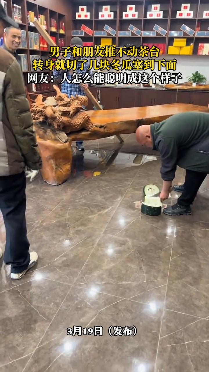 男子和朋友推不动茶台，转身就切了几块冬瓜塞到下面。网友：人怎么能聪明成这个样子？
