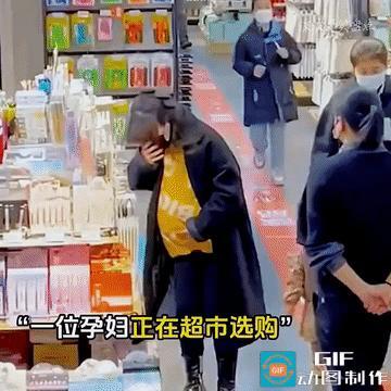 泪目了！一名孕妇正在超市里慢慢选购东西，一男子在经过孕妇身边的时候一直盯着她的后