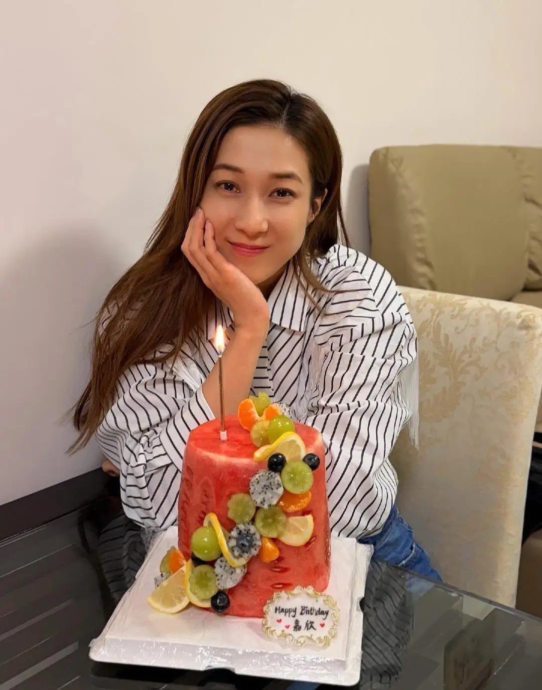 钟嘉欣和朋友一起庆祝42岁生日，她打扮时尚又大方，她穿着白色细条纹衬衫，皮肤紧致