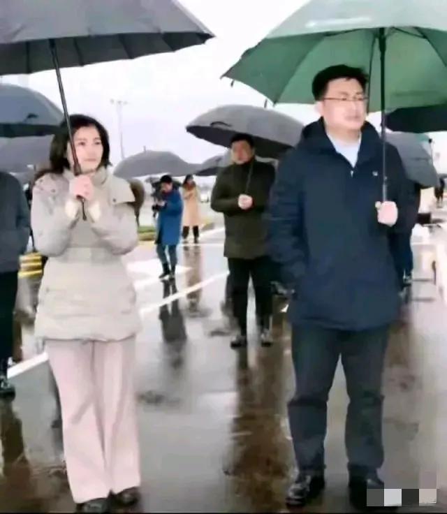 这一张照片，是李佩霞和毛奇两人在户外的一张工作照，寒冷的冬天，天上下着雨，他们俩